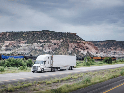 Box truck delivering on the road - FreighWaves article on rail strike affects truckload rates